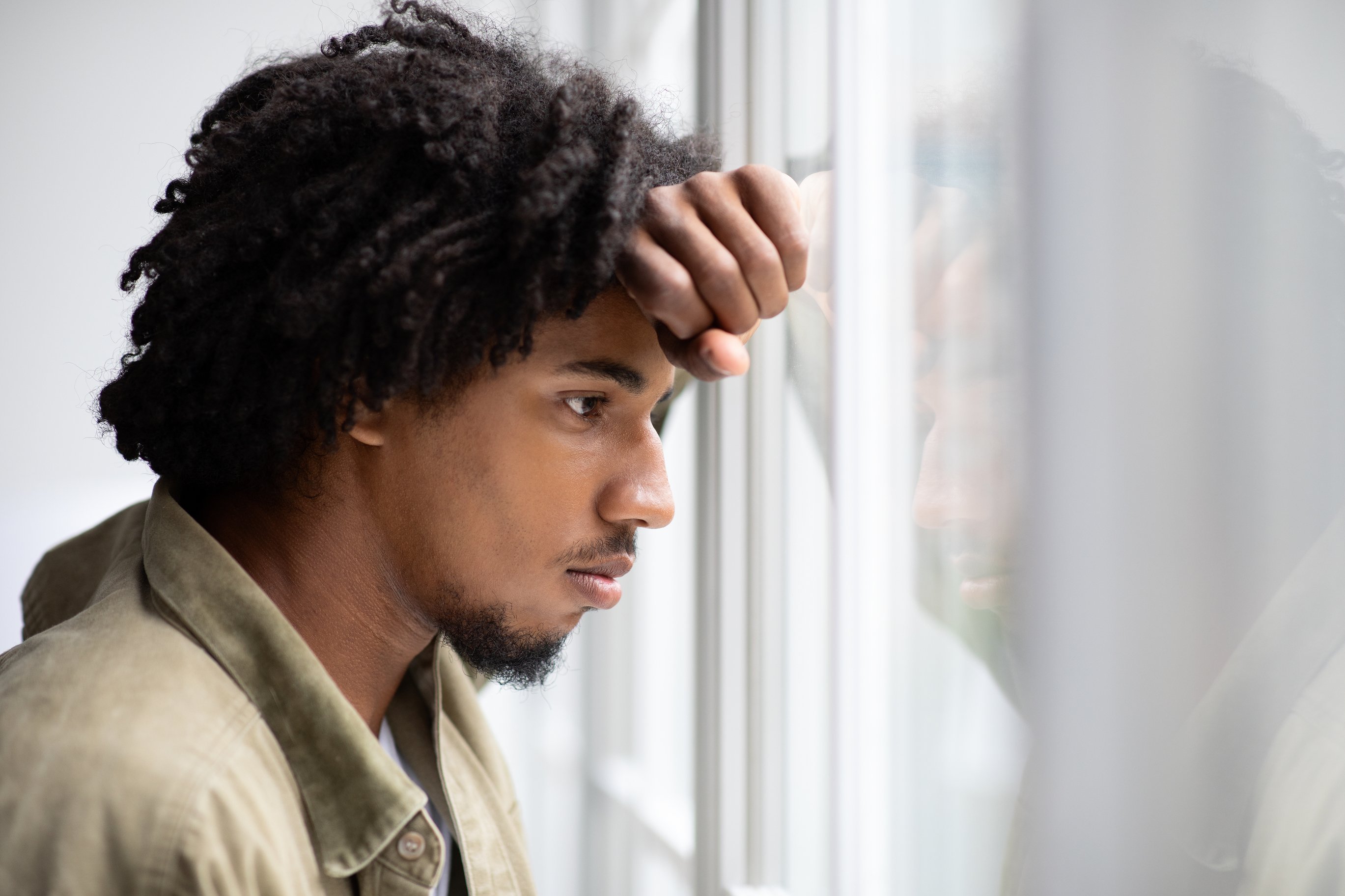 Man looking out window